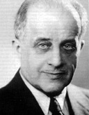 AI generated: The image shows a black and white portrait of a man in a suit. The man is looking directly into the camera.