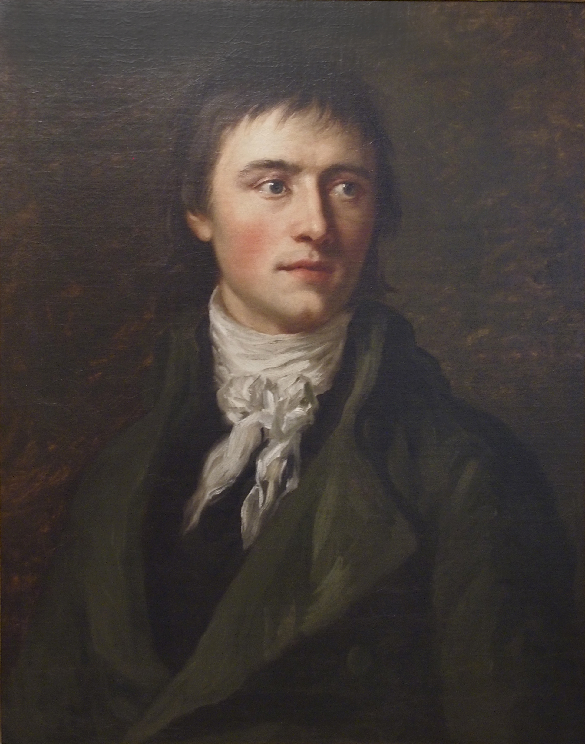 AI generated: The image shows a classic portrait of a young man with a serious expression and a slightly averted gaze. He is wearing elegant, historical clothing including a white scarf.